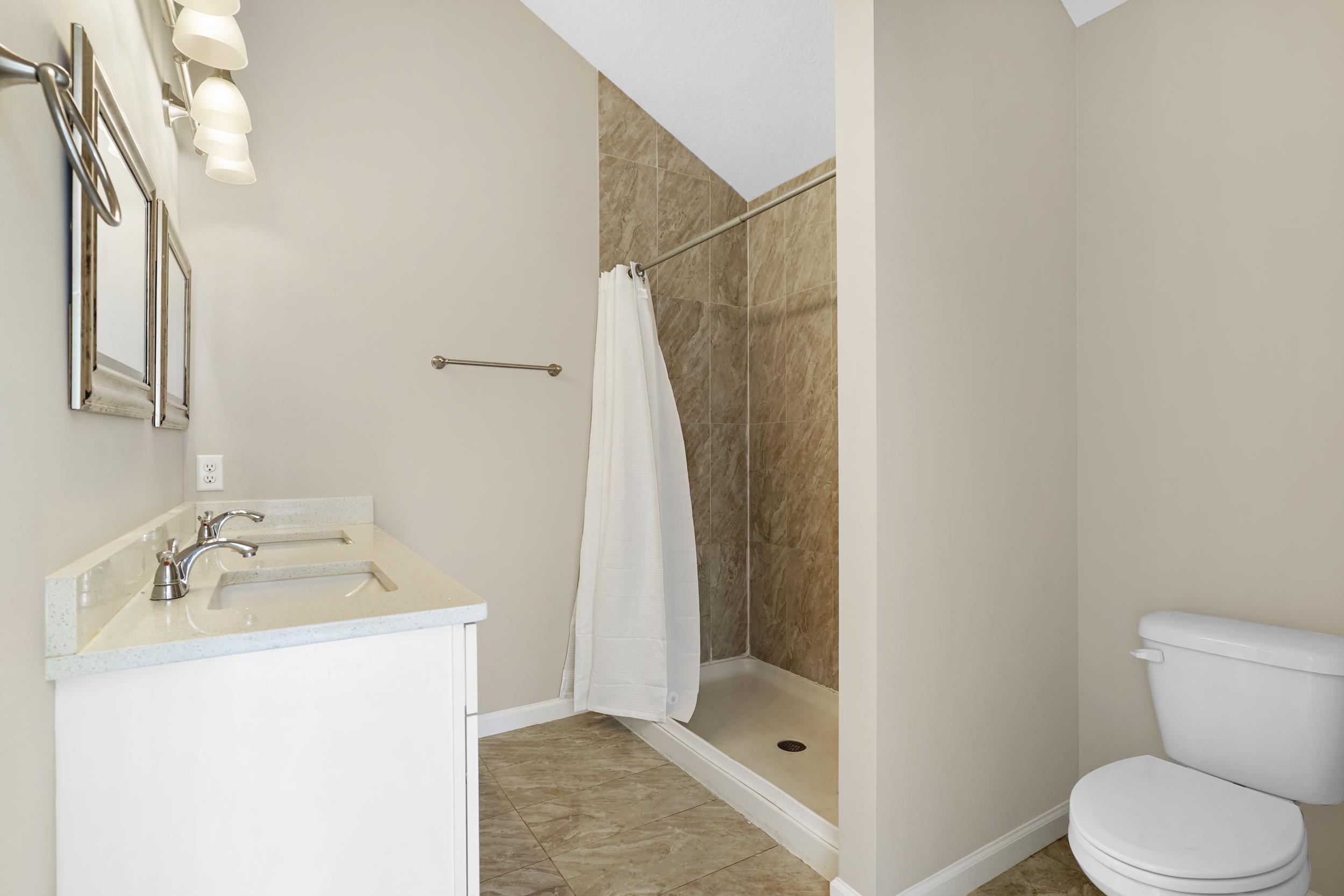 231 Majorca Road St. Augustine, FL 32080 - Photo 11 of 33 a bathroom with a sink toilet and shower