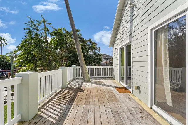 a balcony with wooden floor in front of it