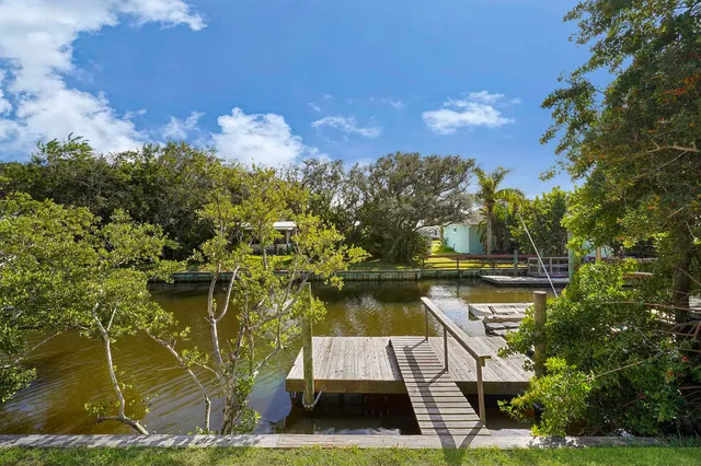 a view of a lake with a house in the background