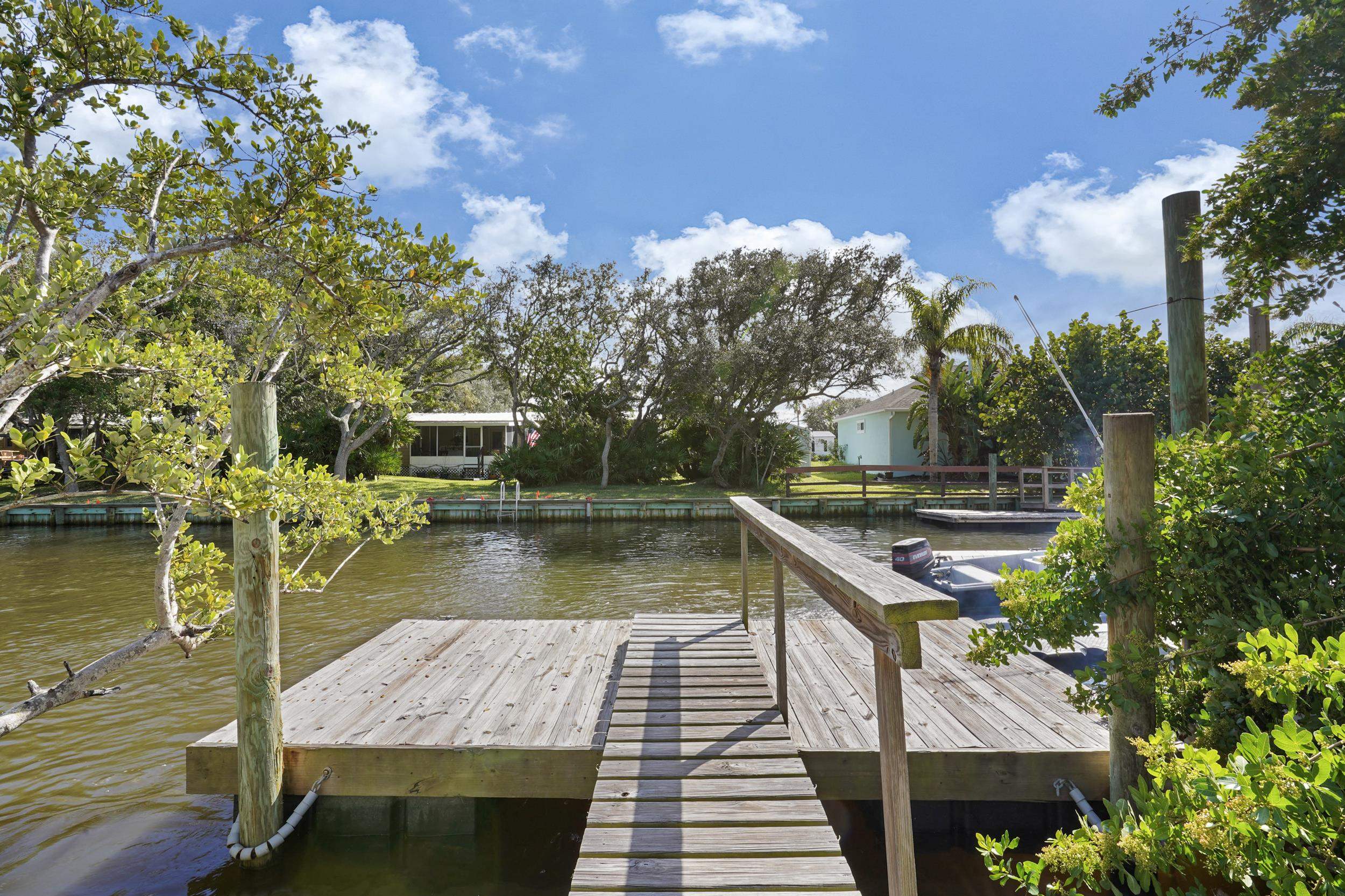 231 Majorca Road St. Augustine, FL 32080 - Photo 3 of 33 a view of a wooden deck and lake with trees in the background