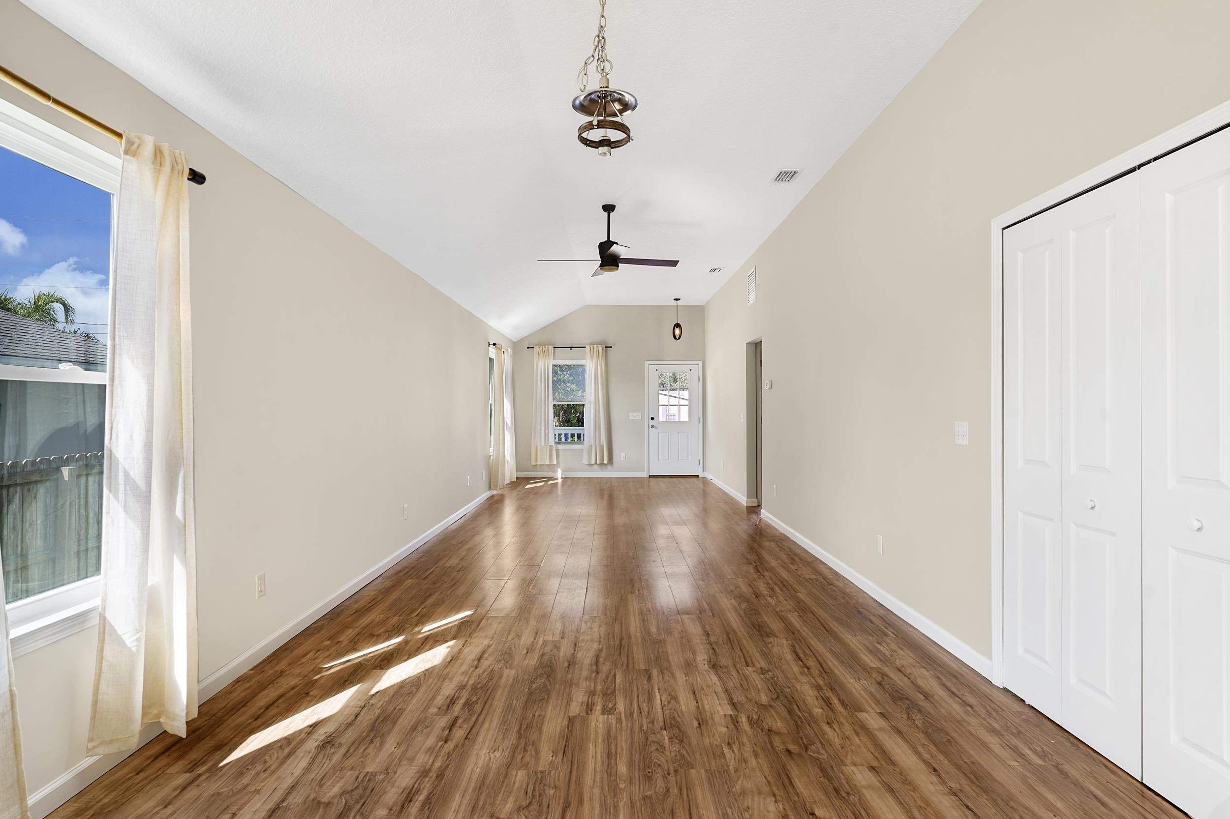 231 Majorca Road St. Augustine, FL 32080 - Photo 5 of 33 a view of a room with wooden floor staircase and a kitchen space