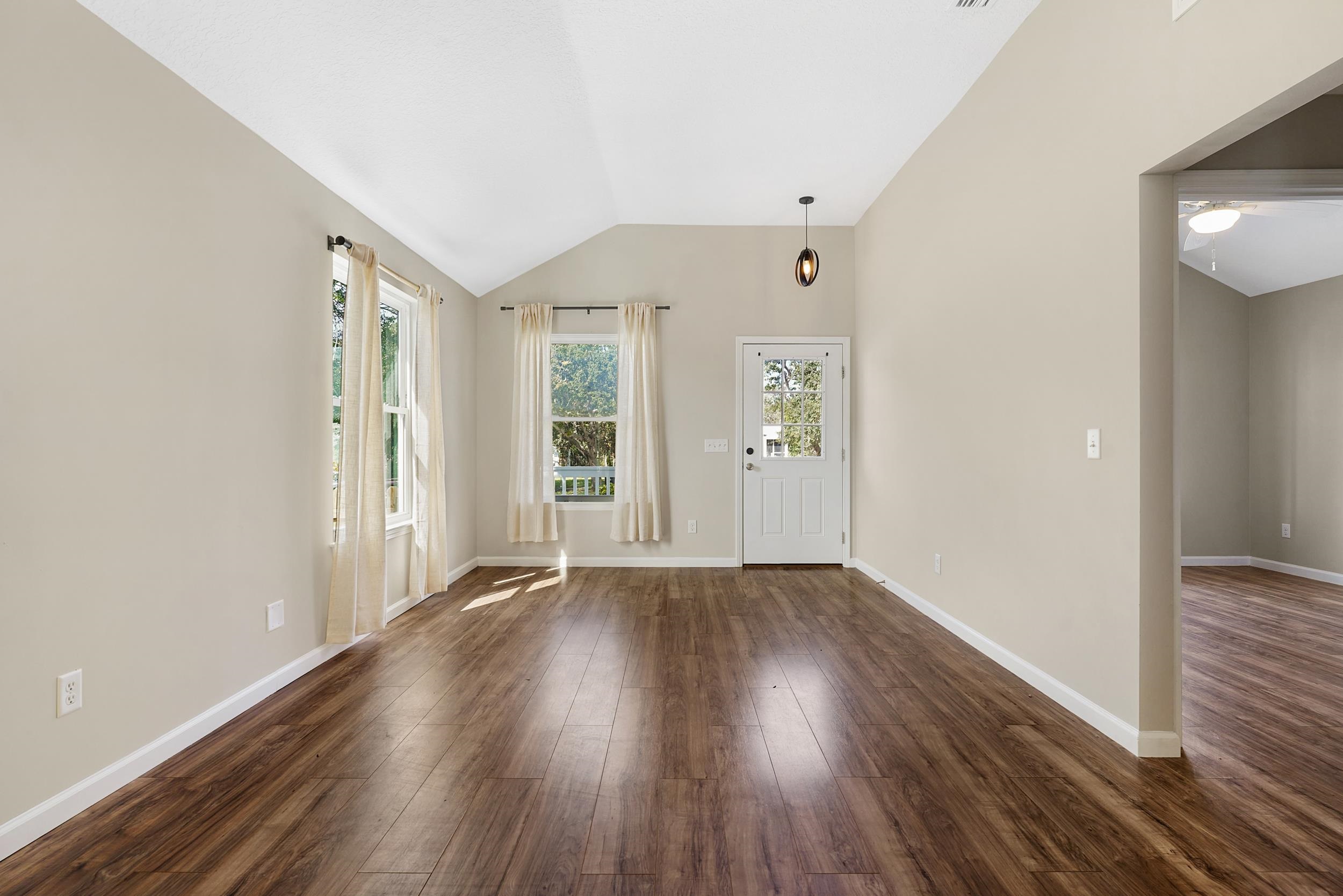 231 Majorca Road St. Augustine, FL 32080 - Photo 6 of 33 wooden floor in an empty room with a window