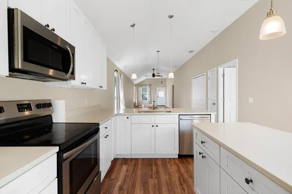 a kitchen with a sink stove and microwave