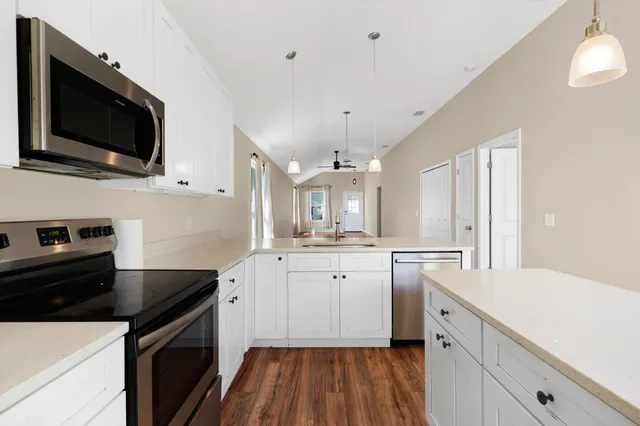 a kitchen with a sink stove and microwave