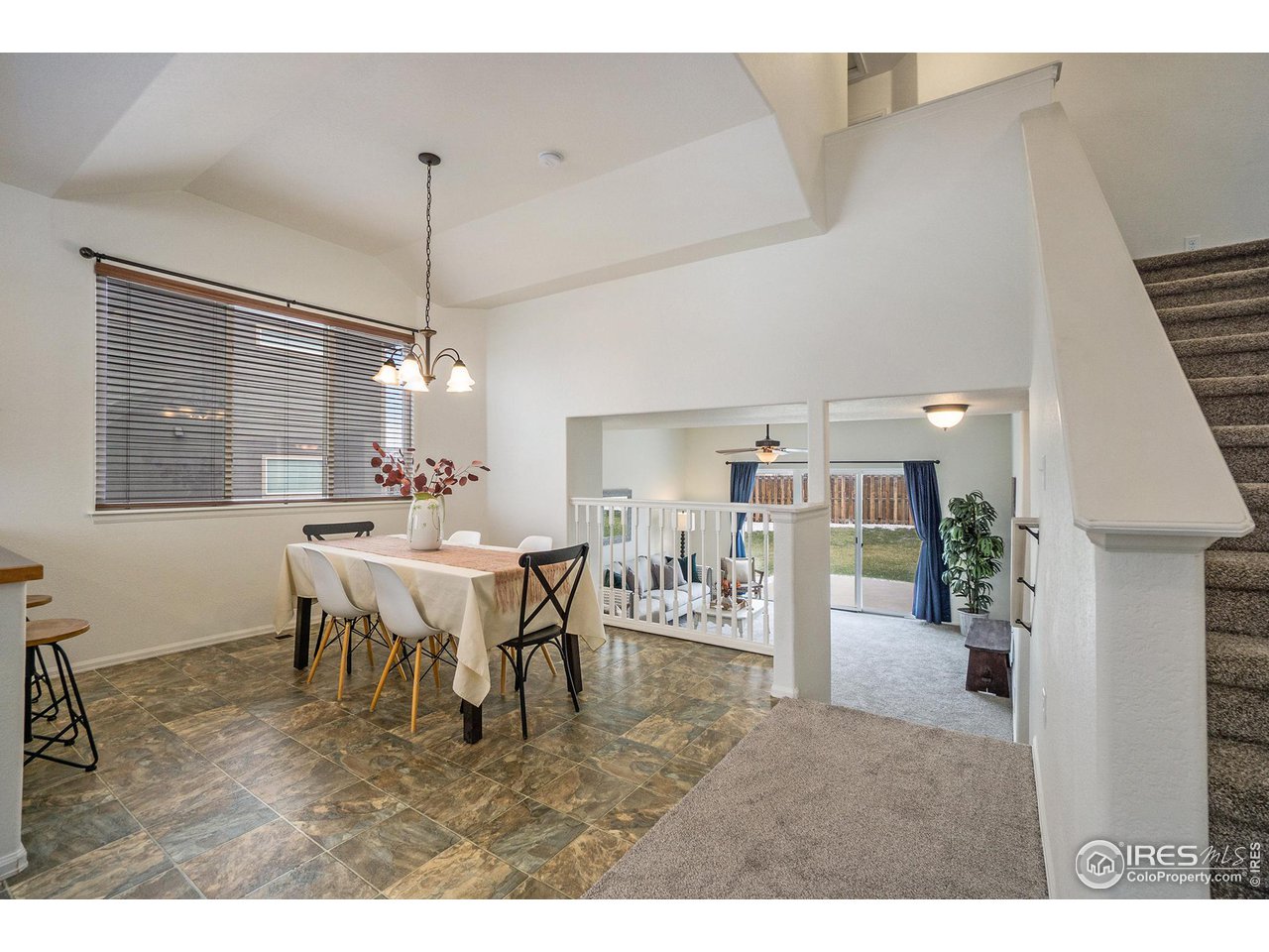 4386 Cypress Ridge Lane Wellington, CO 80549 - Photo 11 of 30 a view of a dining room with furniture and chandelier