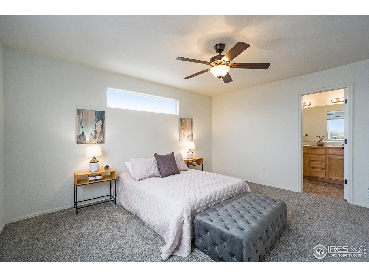 4386 Cypress Ridge Lane Wellington, CO 80549 - Photo 17 of 30 a bedroom with a bed and a chandelier