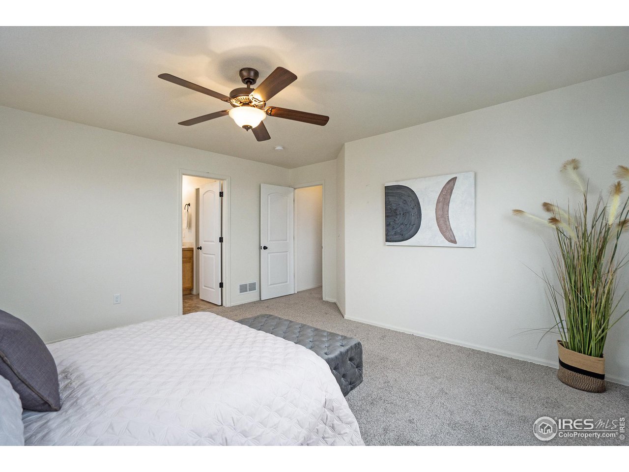 4386 Cypress Ridge Lane Wellington, CO 80549 - Photo 18 of 30 a bedroom with a bed and a potted plant