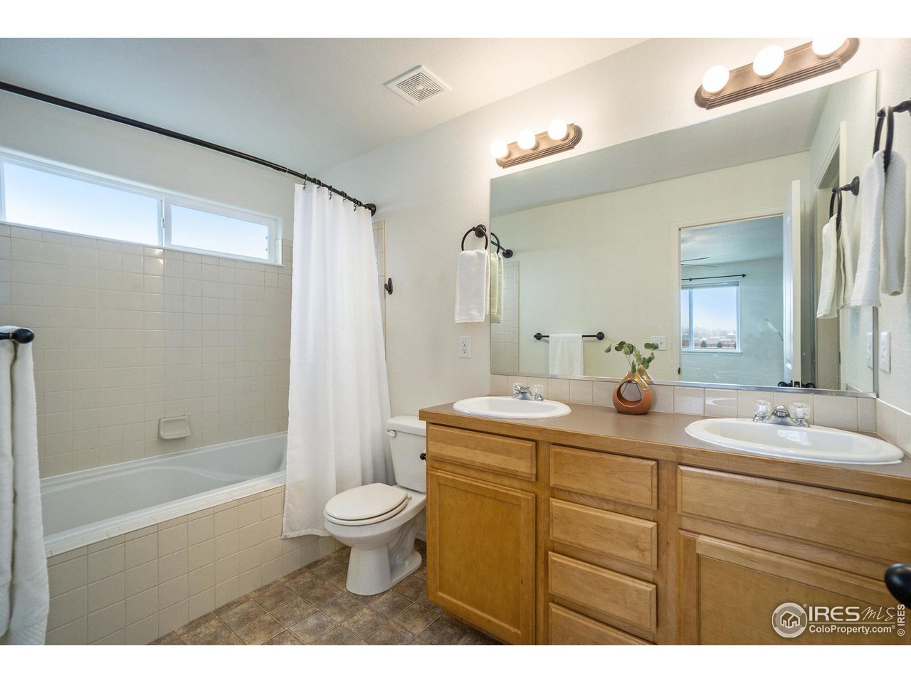 4386 Cypress Ridge Lane Wellington, CO 80549 - Photo 24 of 30 a bathroom with a sink a toilet and shower
