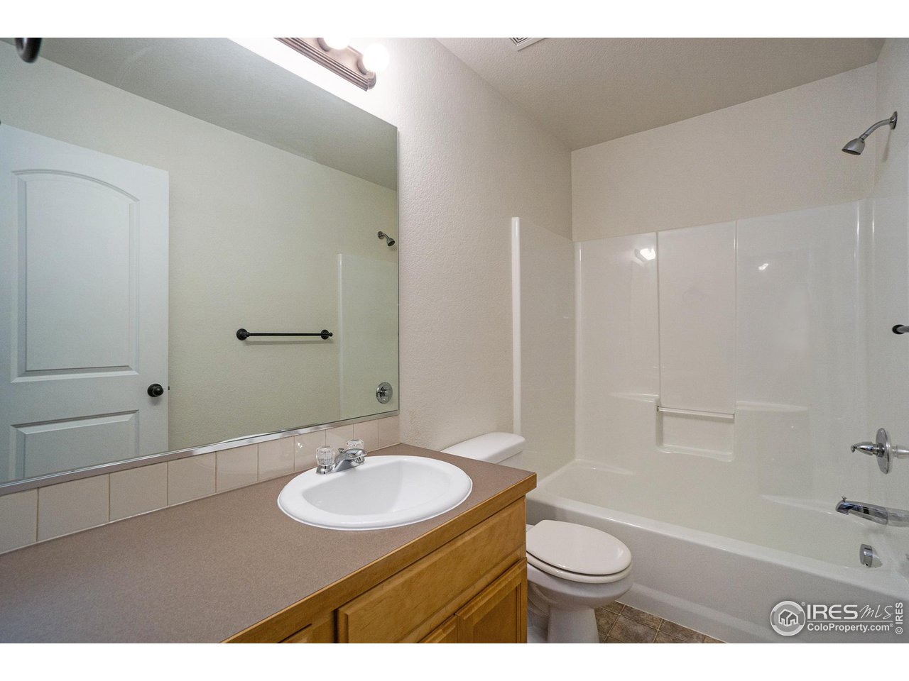 4386 Cypress Ridge Lane Wellington, CO 80549 - Photo 25 of 30 a bathroom with a sink a toilet and shower
