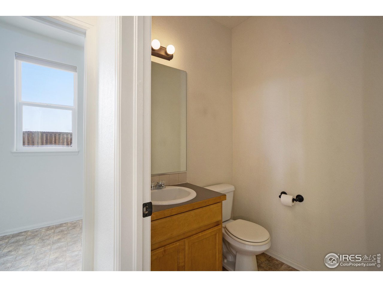 4386 Cypress Ridge Lane Wellington, CO 80549 - Photo 26 of 30 a bathroom with a toilet sink vanity and mirror
