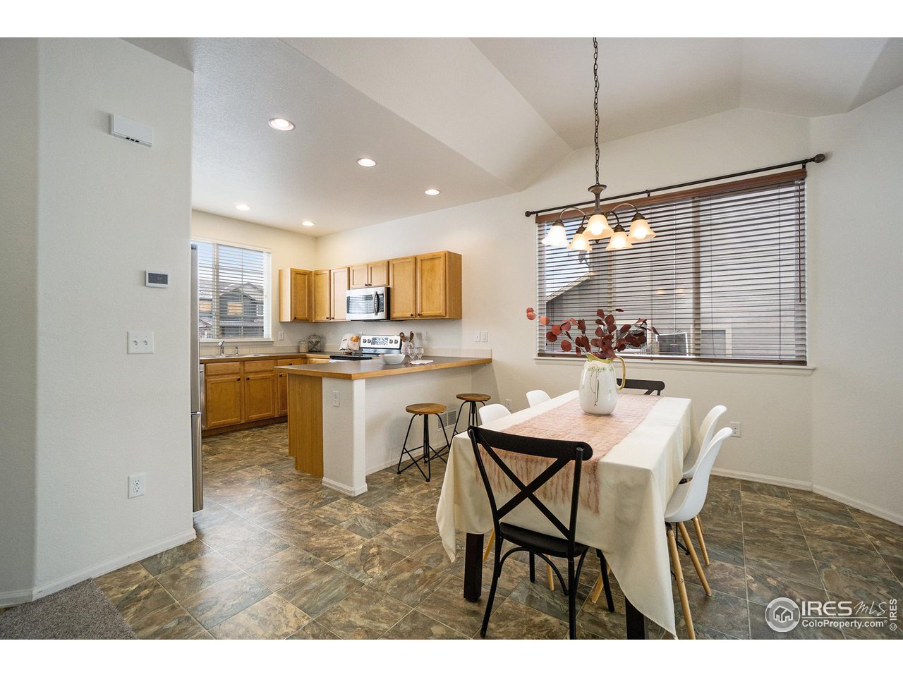 4386 Cypress Ridge Lane Wellington, CO 80549 - Photo 8 of 30 a kitchen with a table and chairs in it