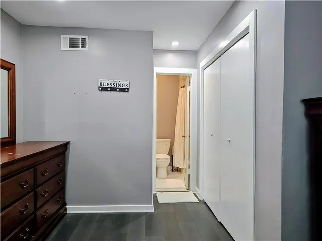 a bedroom with a bed and a dresser