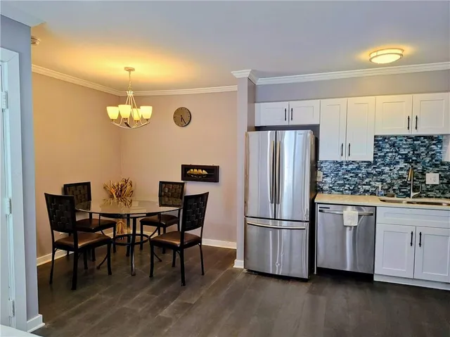 a view of a yard with plants and trees