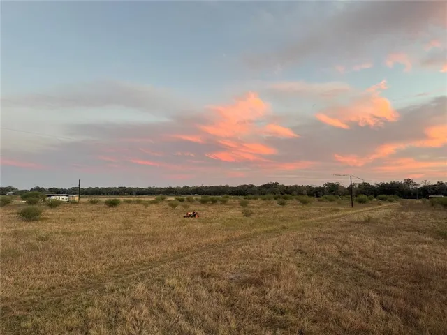a view of a lake with sunset