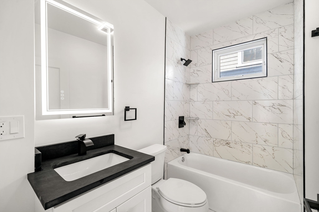 53 Dustin Street, Unit 2 Boston, MA 02135 - Photo 13 of 21 a bathroom with a sink a toilet and bathtub