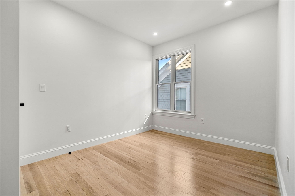 53 Dustin Street, Unit 2 Boston, MA 02135 - Photo 14 of 21 a view of empty room with wooden floor and fan