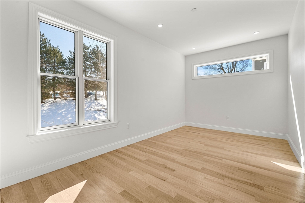 53 Dustin Street, Unit 2 Boston, MA 02135 - Photo 8 of 21 a view of empty room with wooden floor and fan