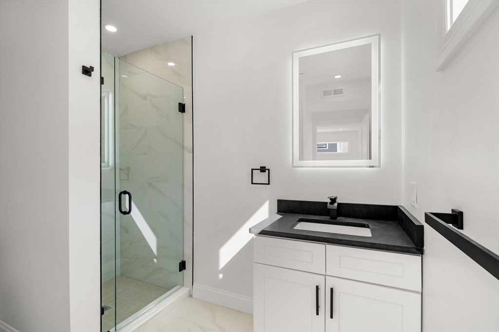 53 Dustin Street, Unit 2 Boston, MA 02135 - Photo 9 of 21 a bathroom with a sink and a mirror