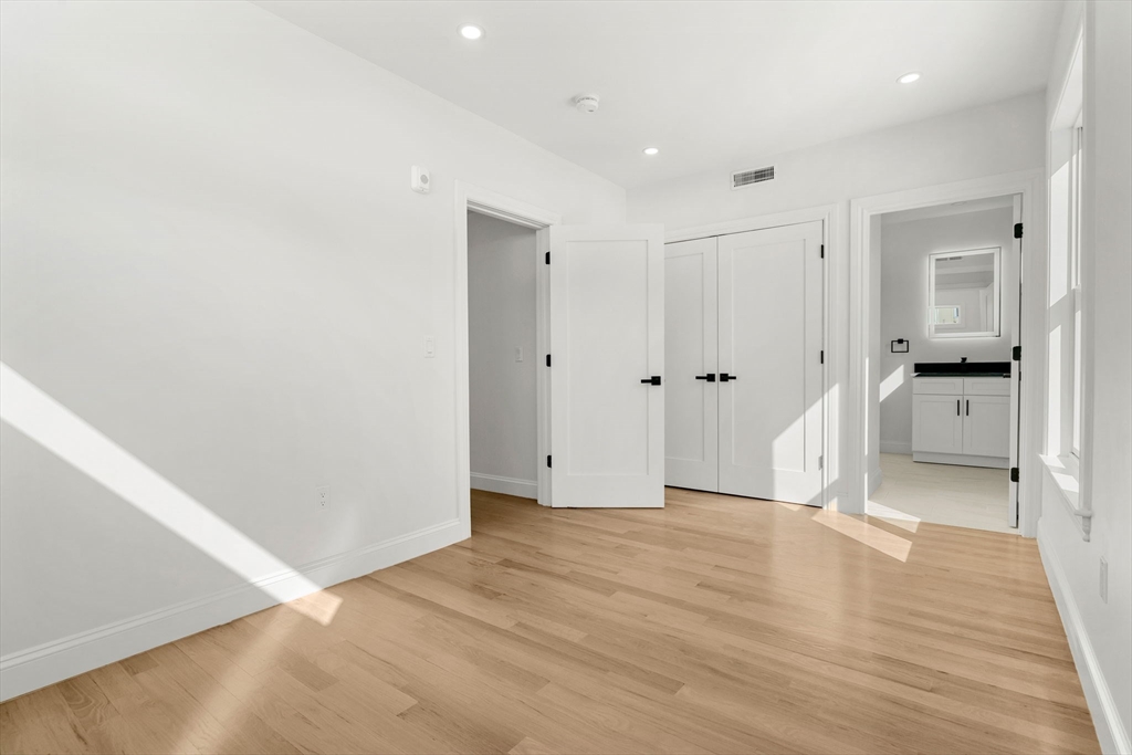 53 Dustin Street, Unit 2 Boston, MA 02135 - Photo 10 of 21 a view of a big room with wooden floor and a bathroom