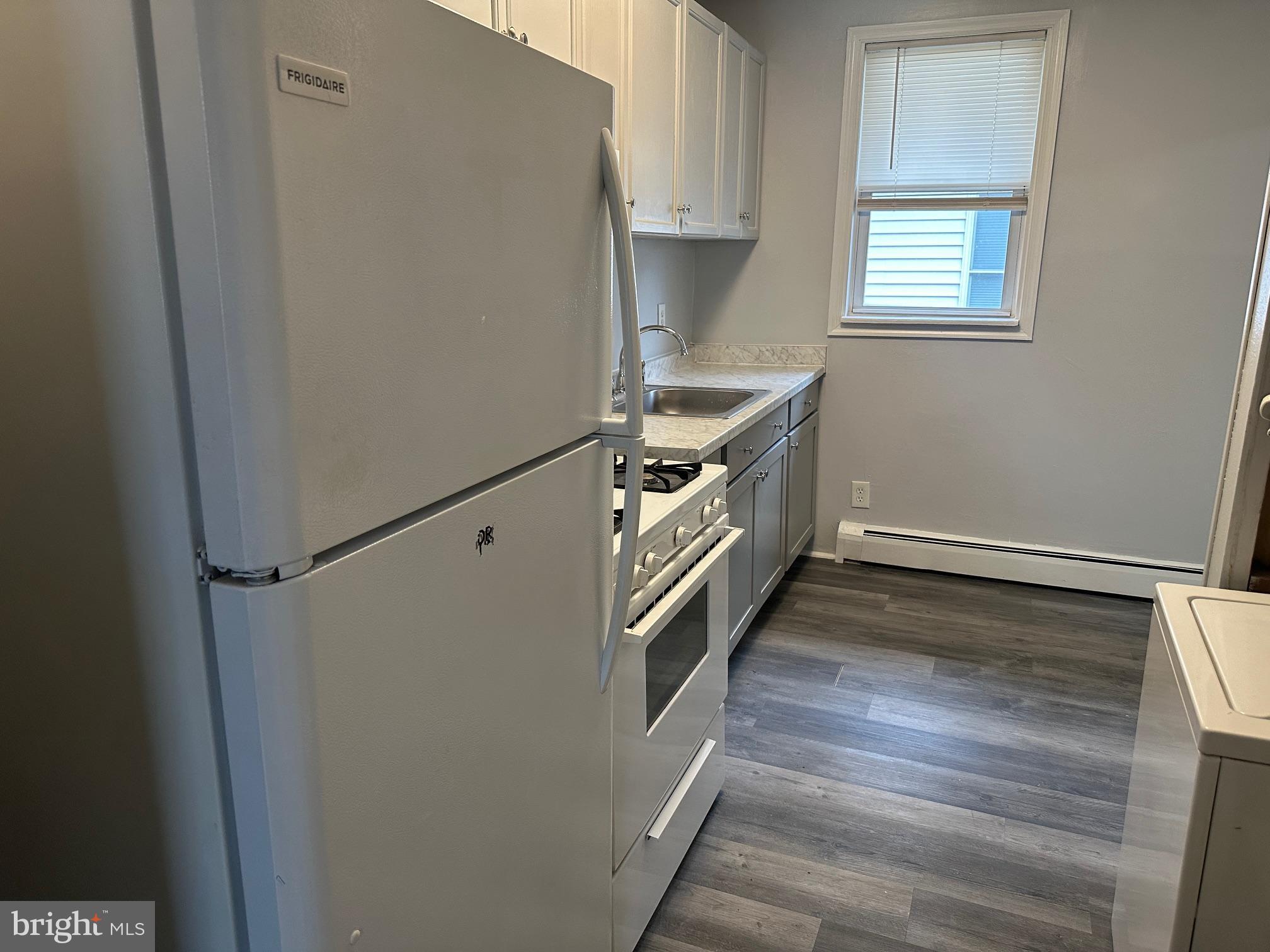 416 Cleveland Road Linthicum Heights, MD 21090 - Photo 11 of 17 a kitchen with a stove and a refrigerator