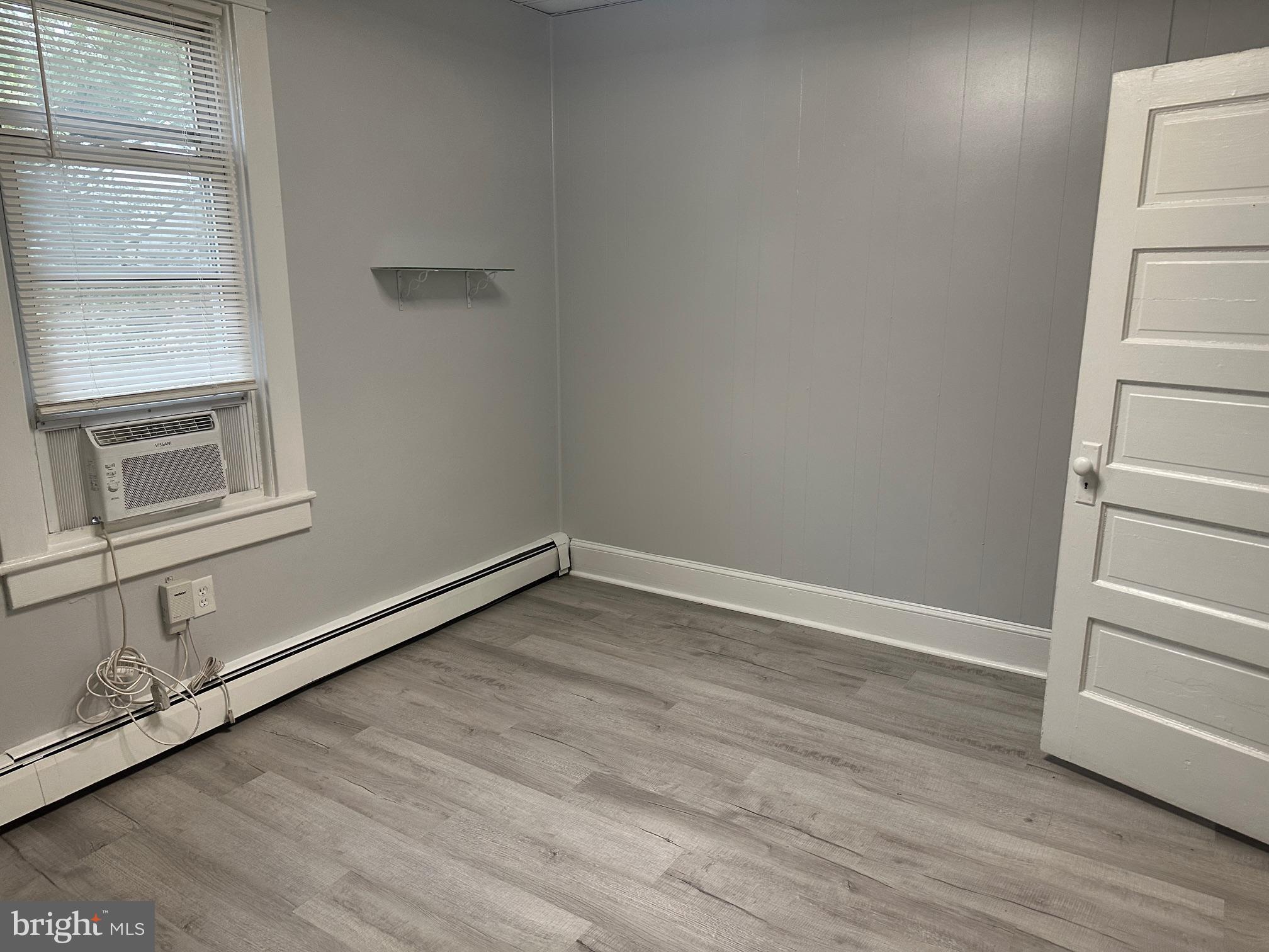 416 Cleveland Road Linthicum Heights, MD 21090 - Photo 14 of 17 a view of an empty room with wooden floor and a window