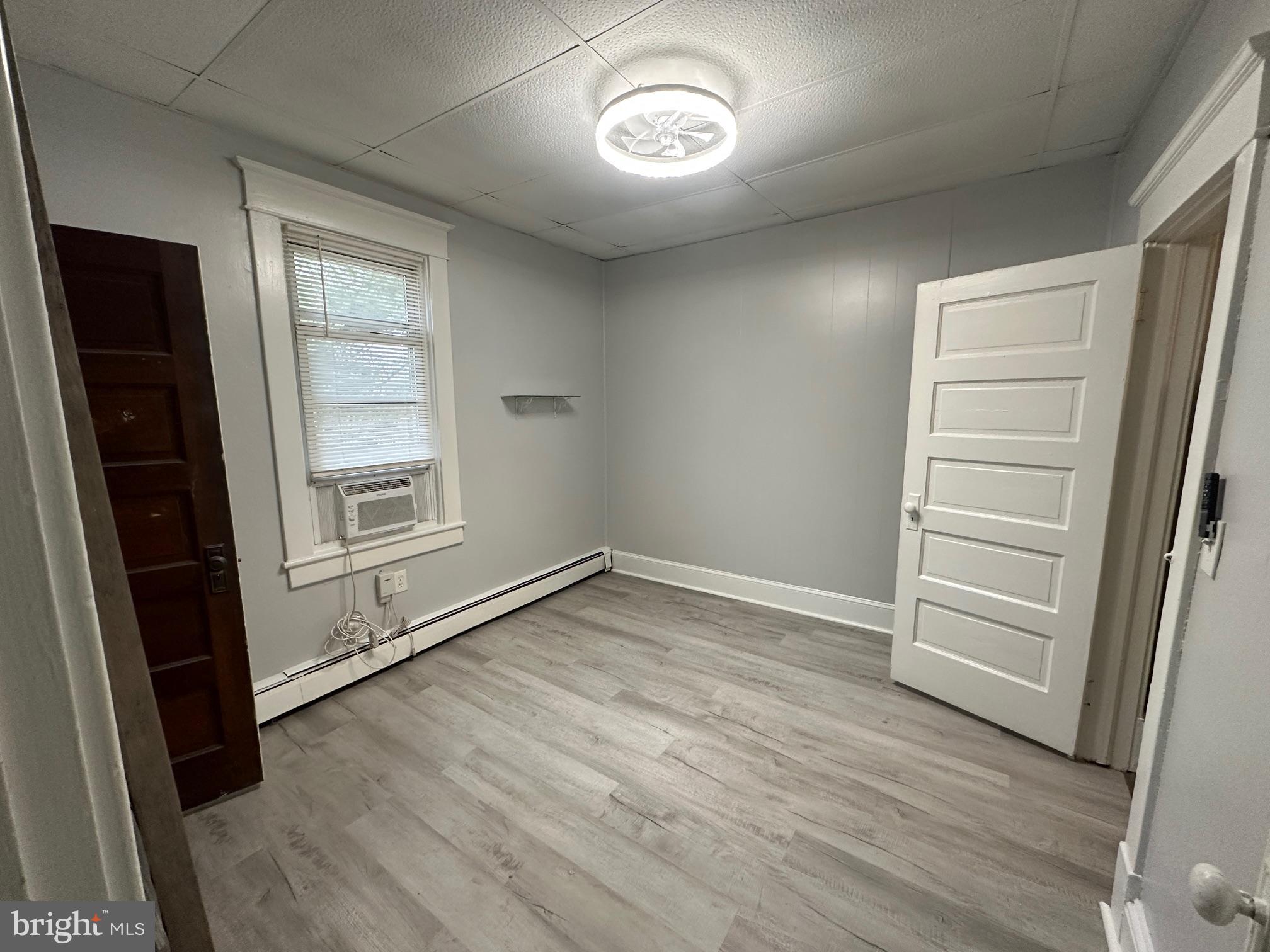 416 Cleveland Road Linthicum Heights, MD 21090 - Photo 15 of 17 an empty room with wooden floor cabinet and windows