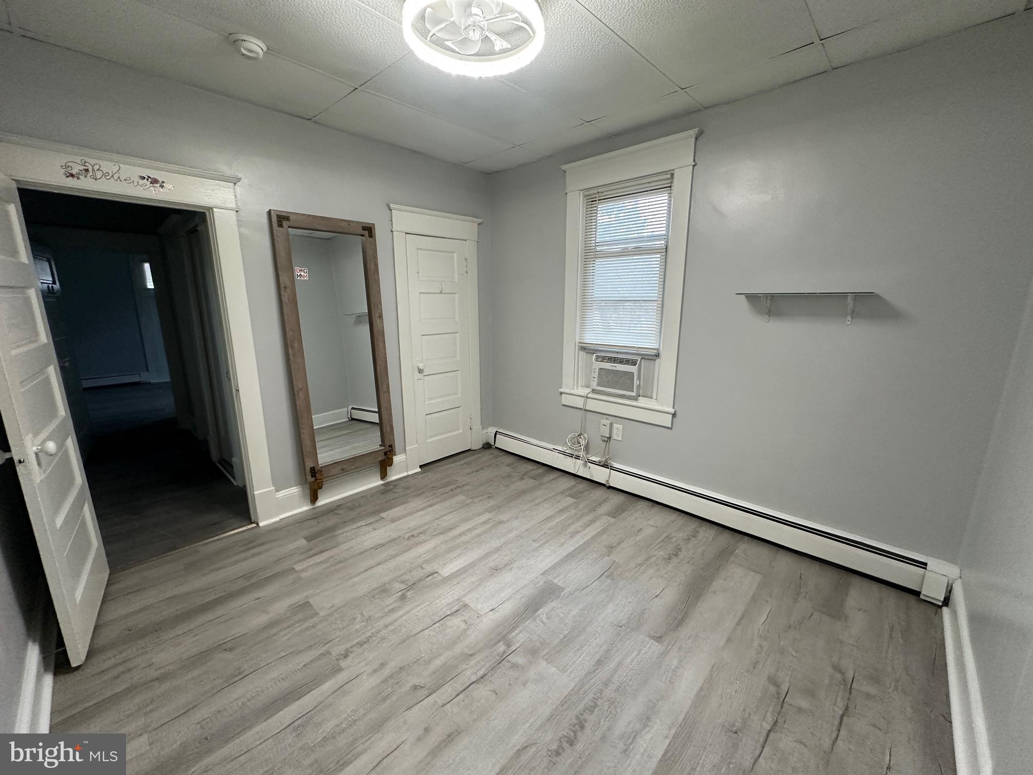 416 Cleveland Road Linthicum Heights, MD 21090 - Photo 16 of 17 an empty room with wooden floor and windows