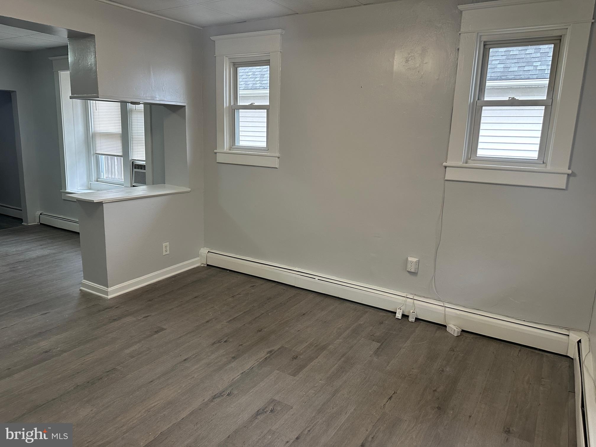 416 Cleveland Road Linthicum Heights, MD 21090 - Photo 3 of 17 an empty room with wooden floor and windows