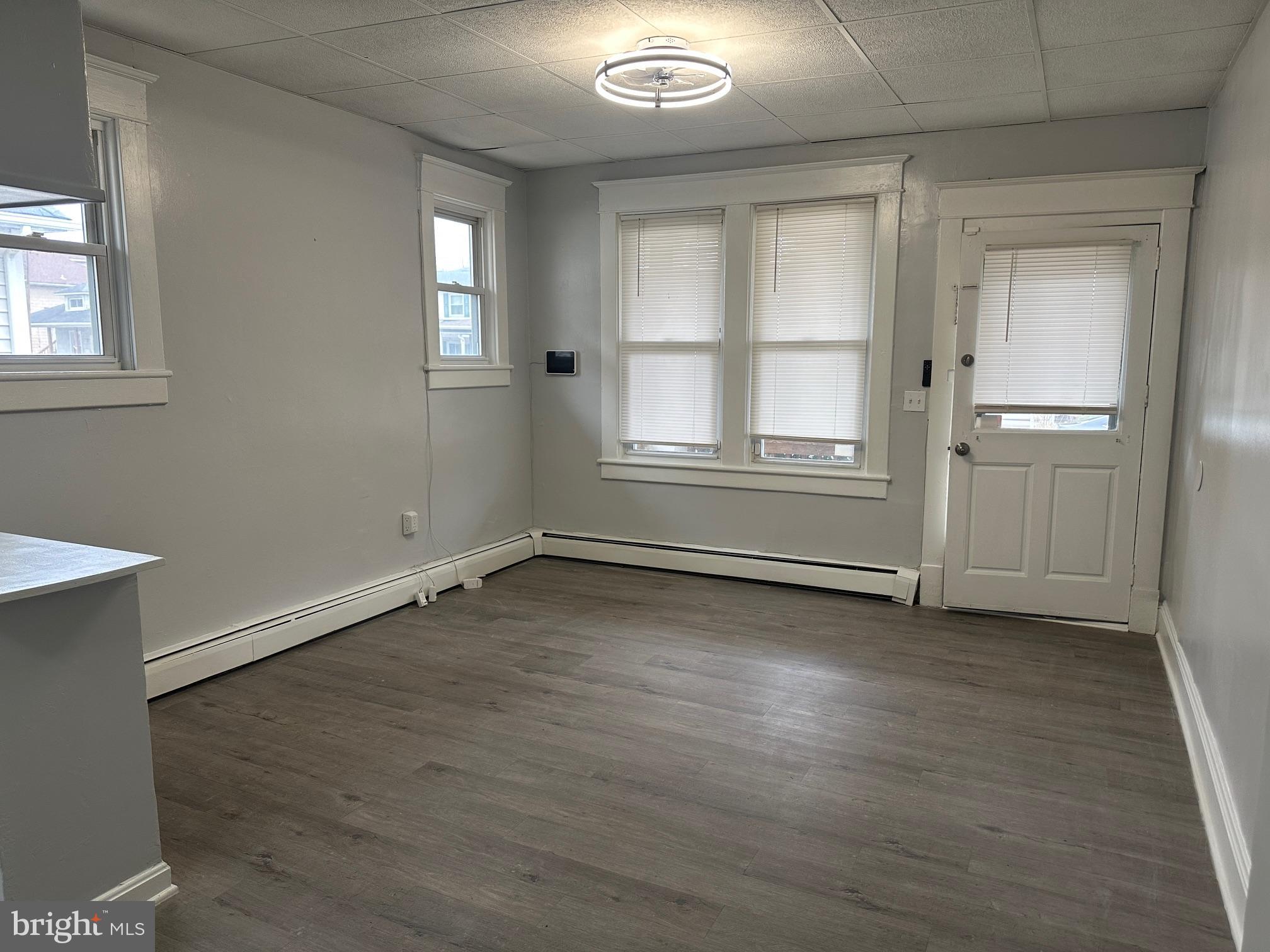 416 Cleveland Road Linthicum Heights, MD 21090 - Photo 4 of 17 an empty room with wooden floor and windows