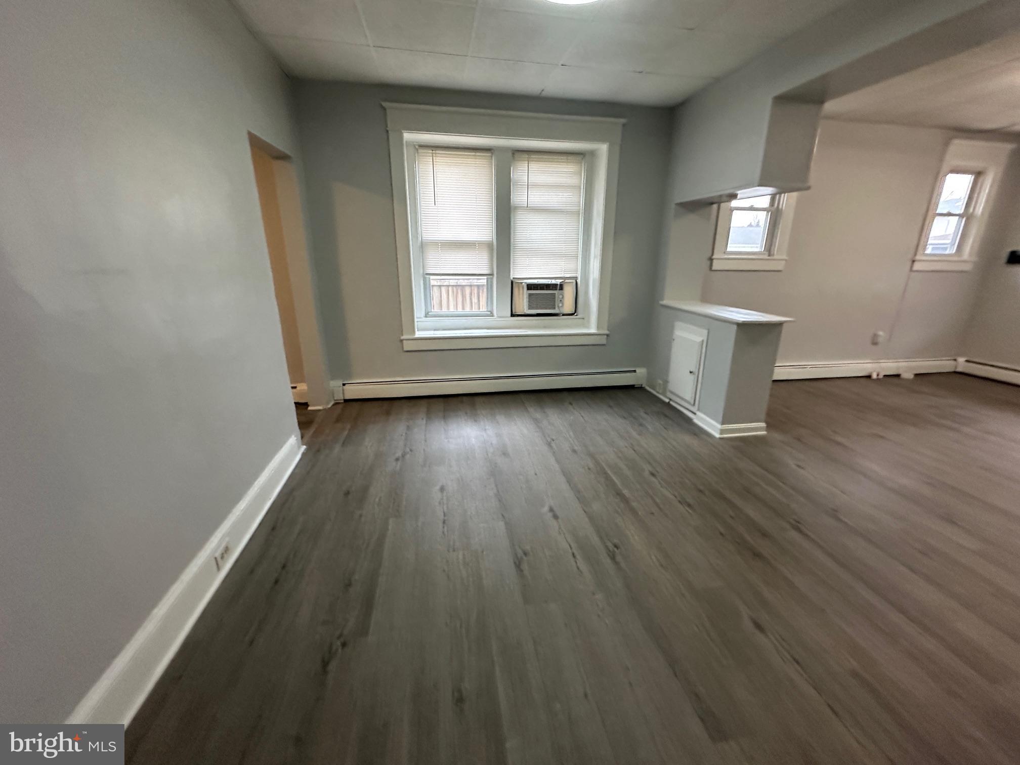 416 Cleveland Road Linthicum Heights, MD 21090 - Photo 7 of 17 an empty room with wooden floor and windows