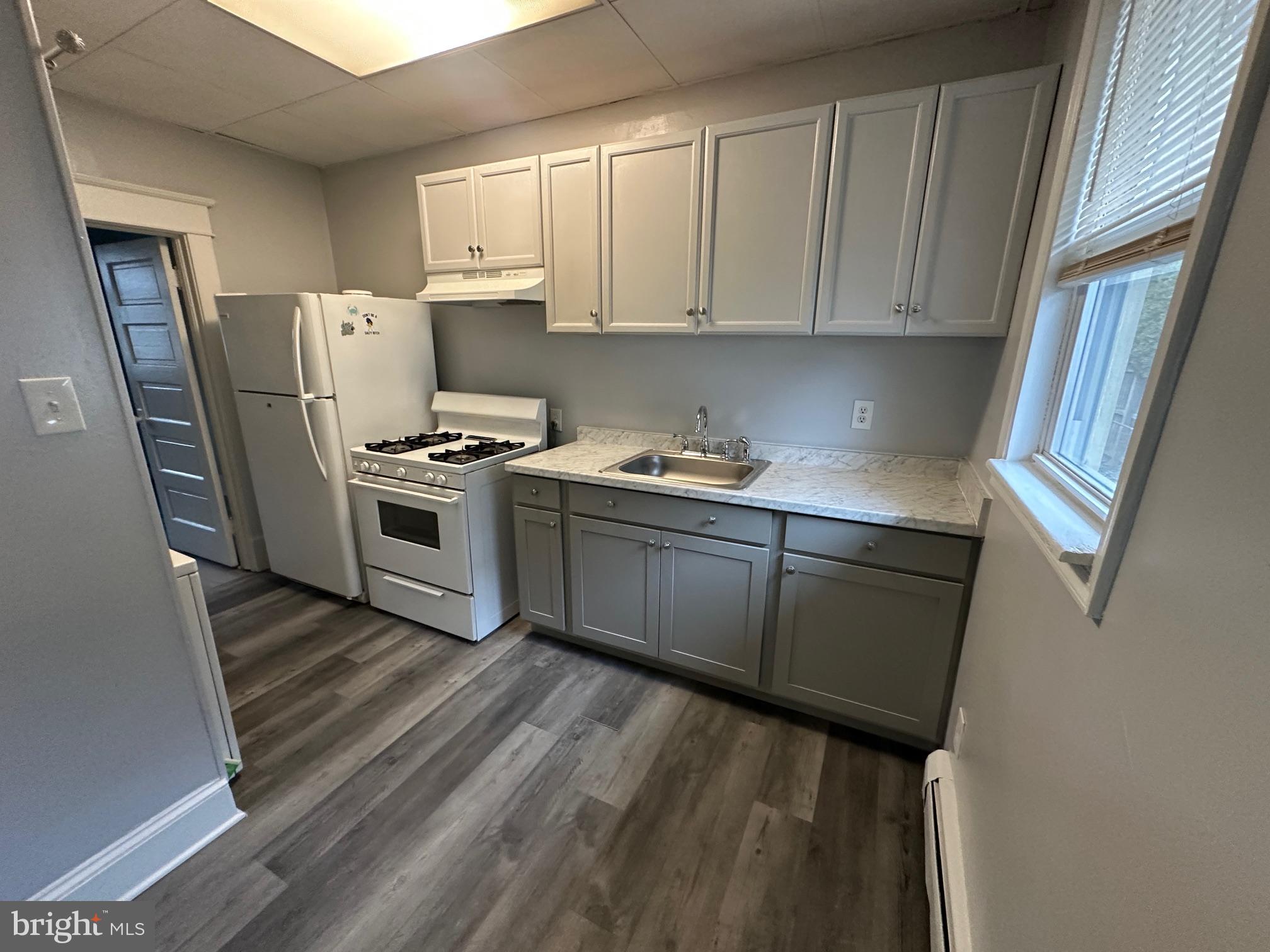 416 Cleveland Road Linthicum Heights, MD 21090 - Photo 10 of 17 a kitchen with a sink a stove and refrigerator