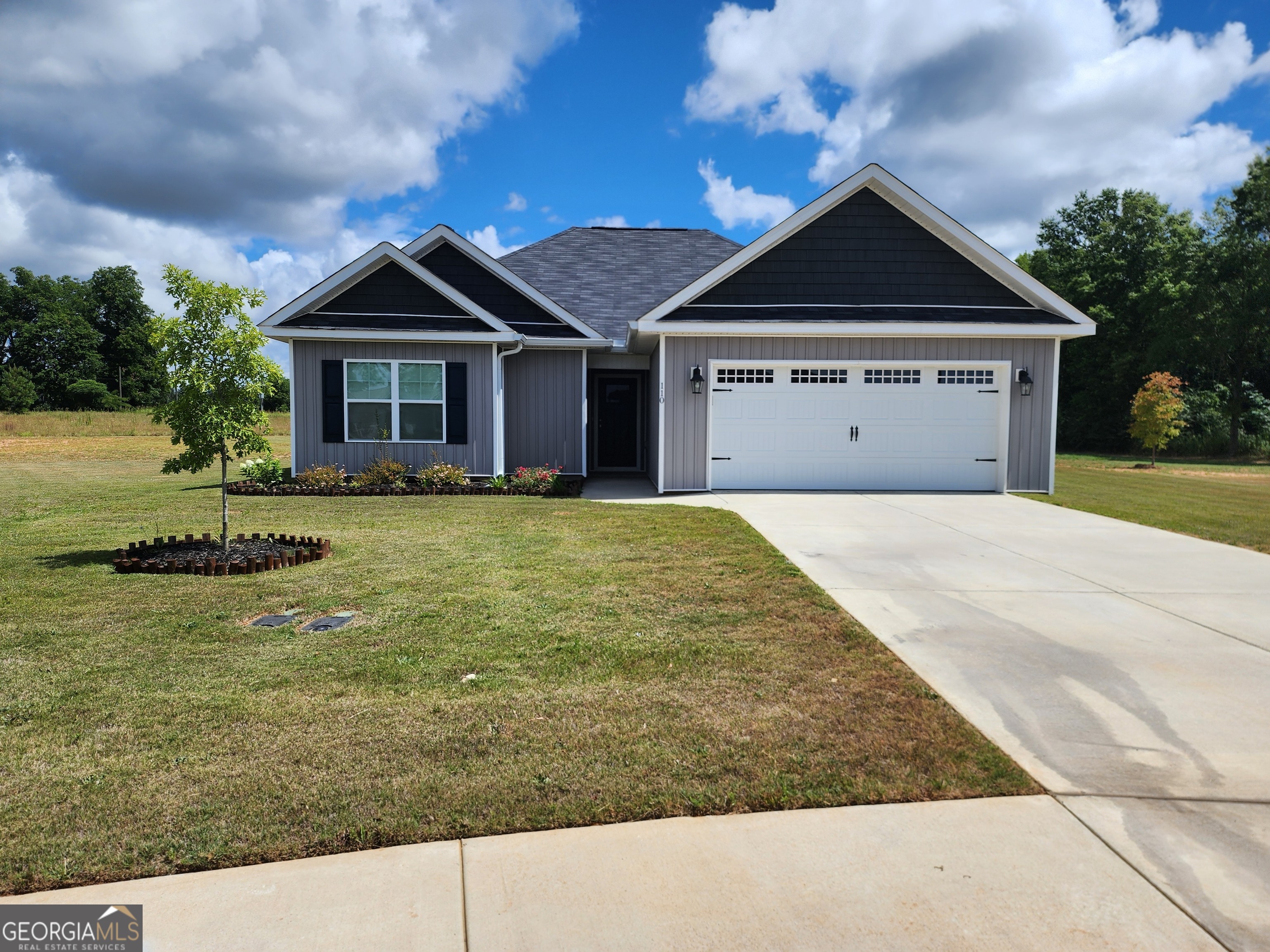 a front view of a house with a yard