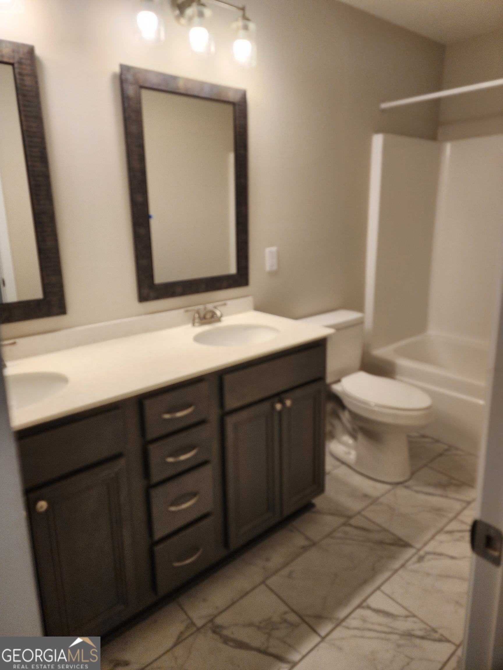 110 Rocky Road Perry, GA 31069 - Photo 4 of 10 a bathroom with a toilet sink and mirror