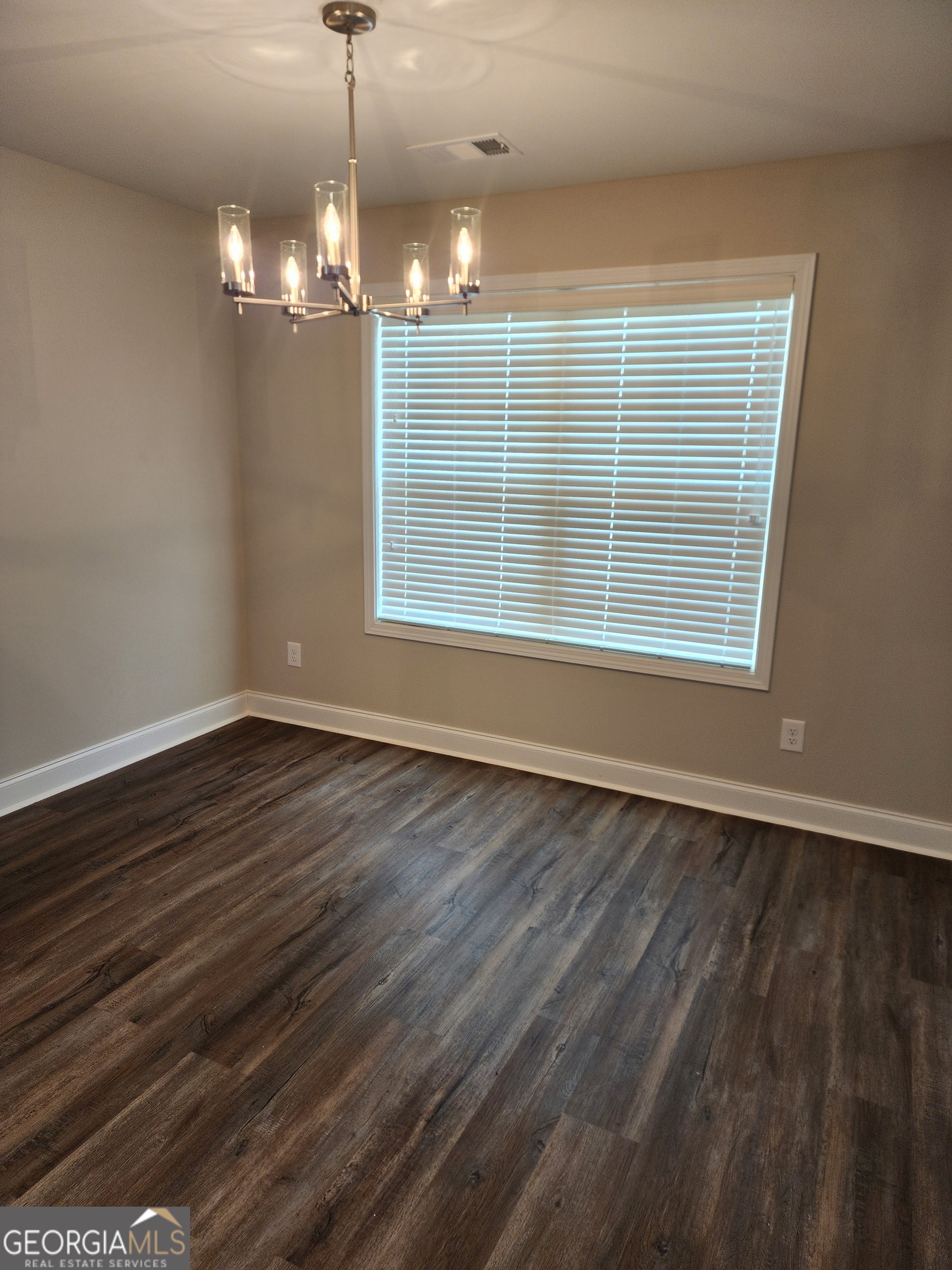 110 Rocky Road Perry, GA 31069 - Photo 5 of 10 a view of an empty room with wooden floor and a window