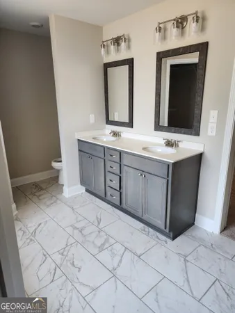 a bathroom with a sink vanity and mirror