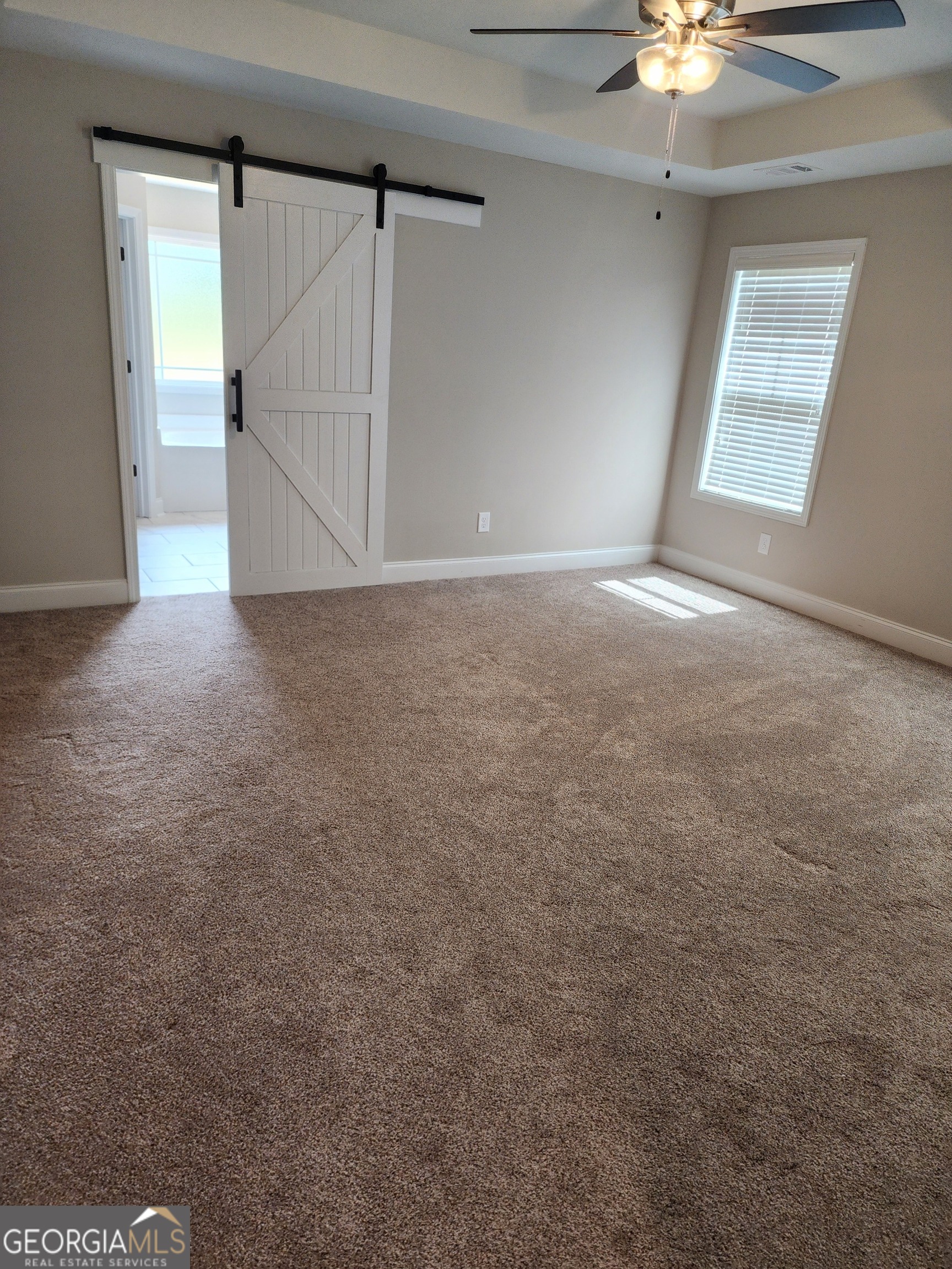 110 Rocky Road Perry, GA 31069 - Photo 9 of 10 en empty room with windows and ceiling fan