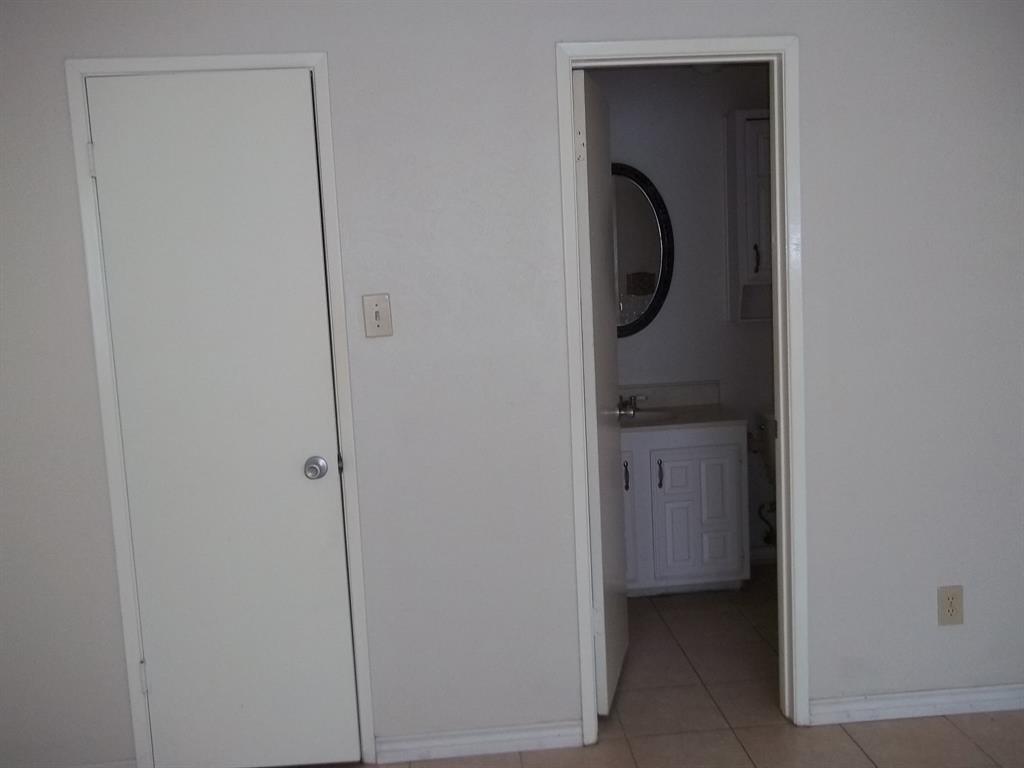 10371 White Elm Road Dallas, TX 75243 - Photo 7 of 11 Hallway featuring baseboards and light tile patterned floors