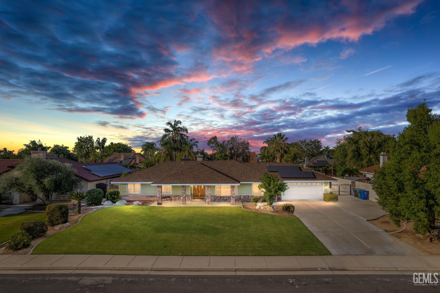 a view of a big house with a big yard