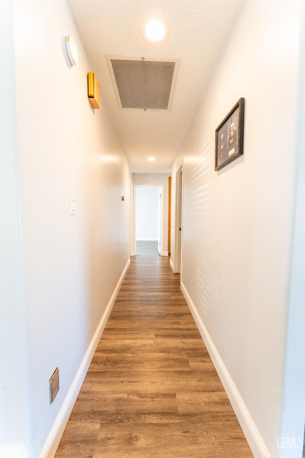 Undisclosed Address Bakersfield, CA 93314 - Photo 11 of 23 a hallway with wooden floor