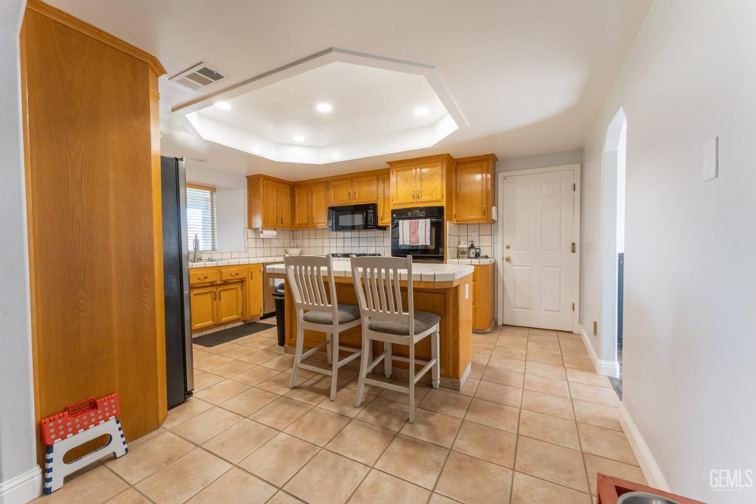 Undisclosed Address Bakersfield, CA 93314 - Photo 12 of 23 a dining room with stainless steel appliances a table and chairs