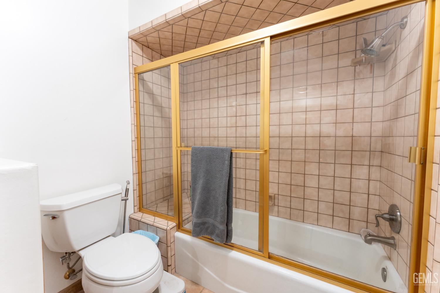 Undisclosed Address Bakersfield, CA 93314 - Photo 14 of 23 a bathroom with a toilet and shower