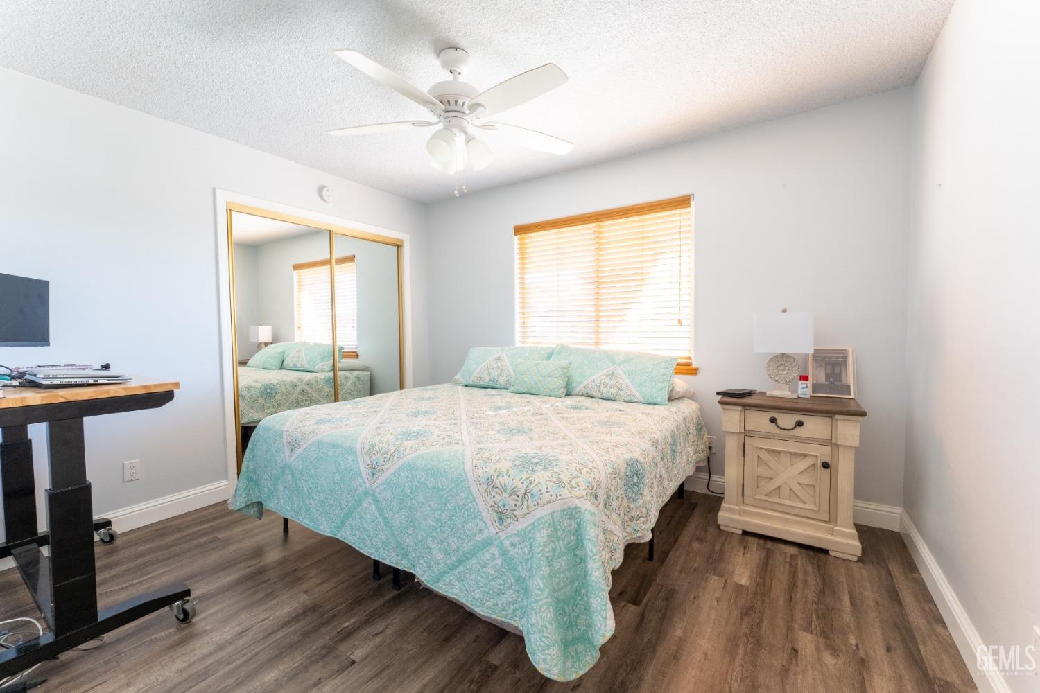 Undisclosed Address Bakersfield, CA 93314 - Photo 15 of 23 a spacious bedroom with a bed and a table