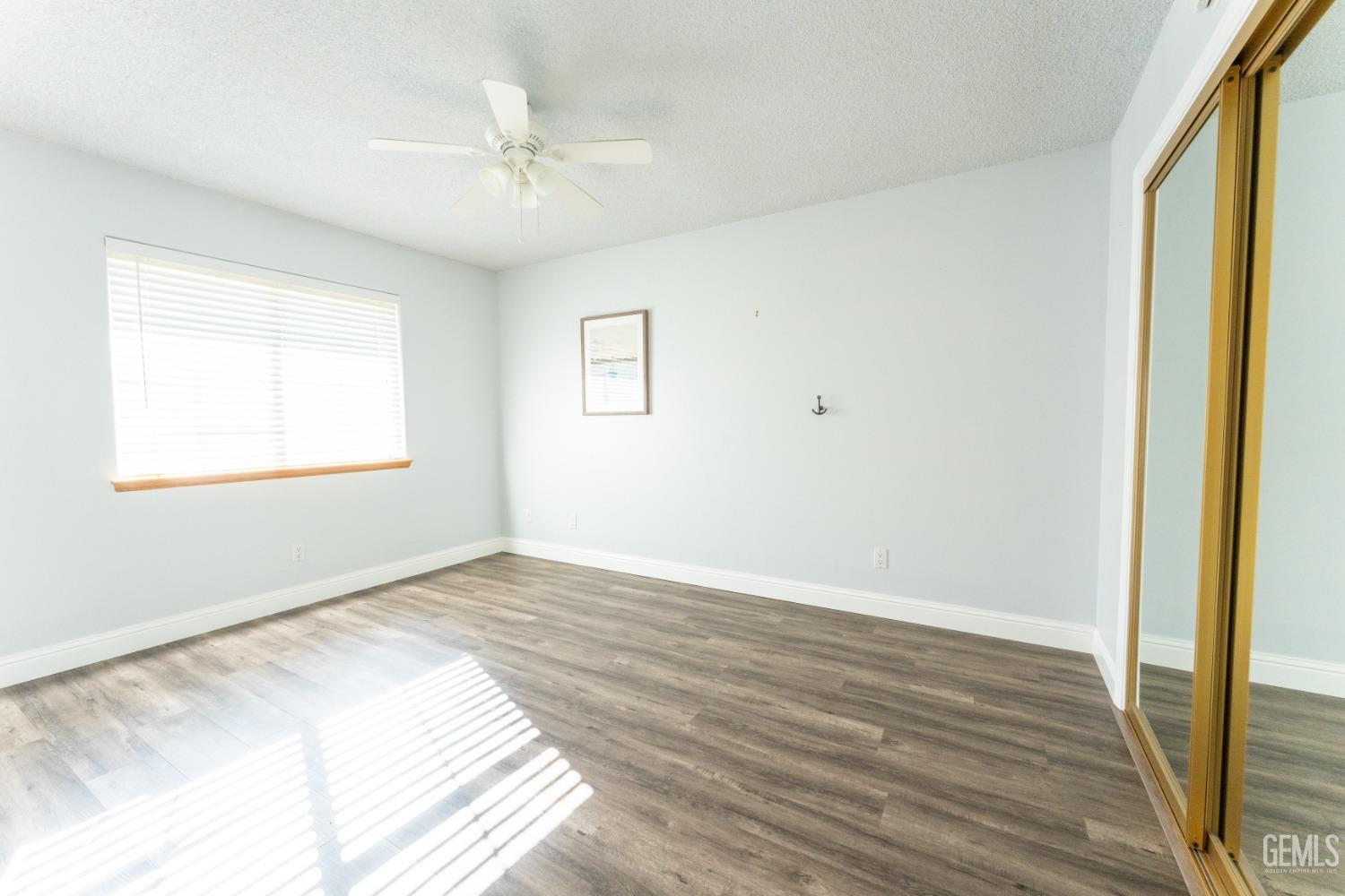 Undisclosed Address Bakersfield, CA 93314 - Photo 16 of 23 a view of an empty room with wooden floor and a window
