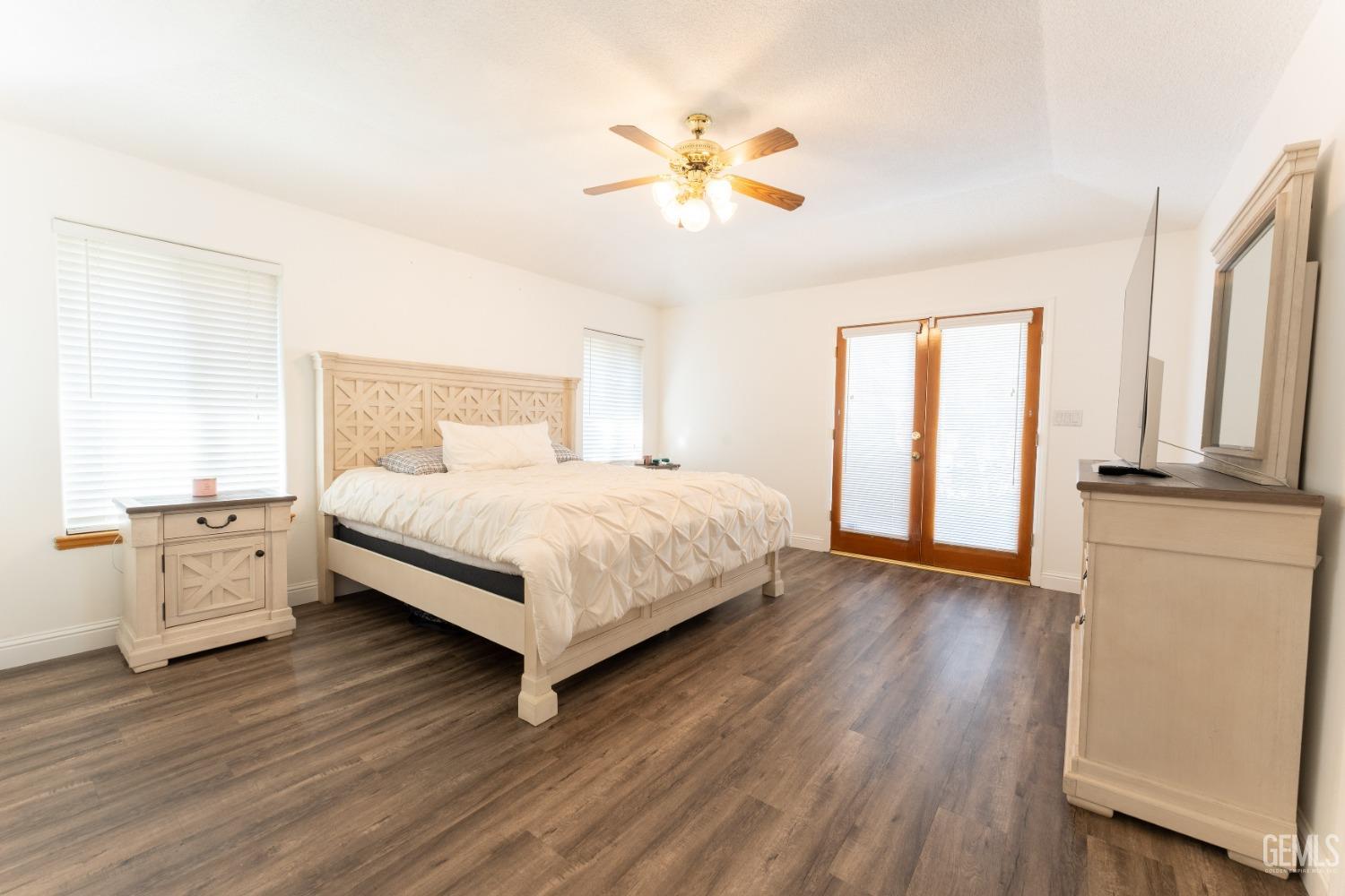 Undisclosed Address Bakersfield, CA 93314 - Photo 18 of 23 a bedroom with a large bed and a chandelier