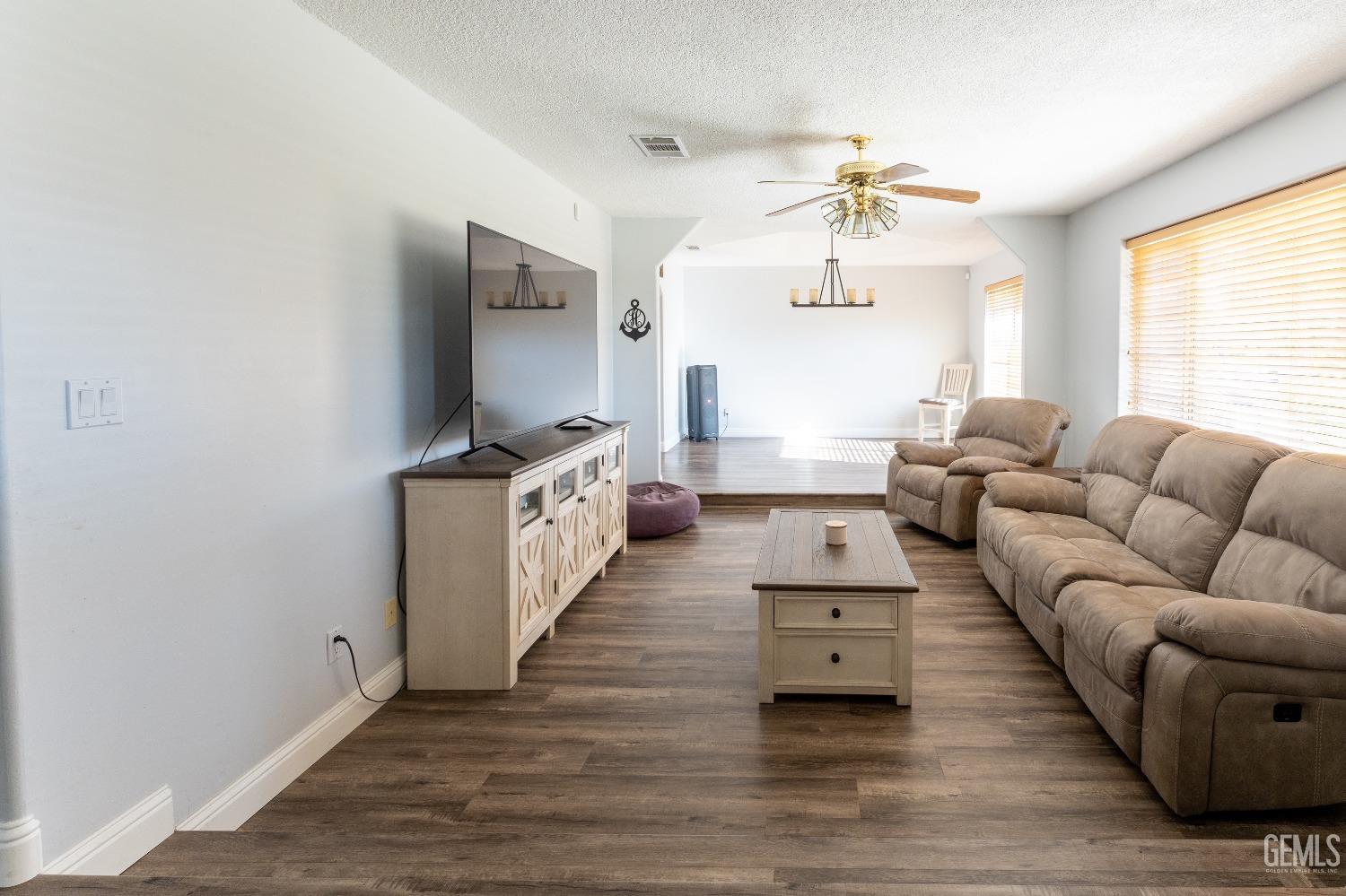 Undisclosed Address Bakersfield, CA 93314 - Photo 4 of 23 a living room with furniture and a flat screen tv