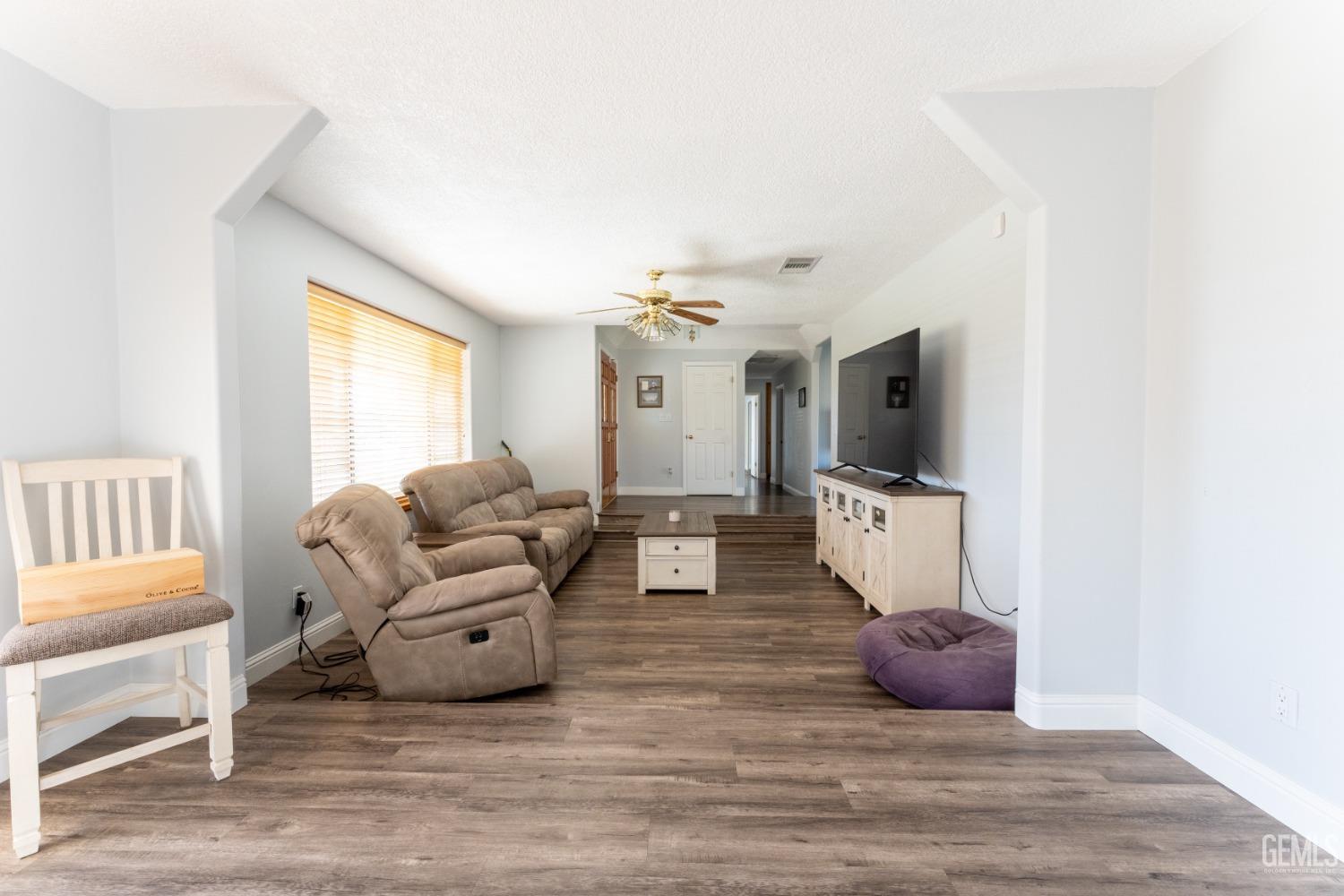 Undisclosed Address Bakersfield, CA 93314 - Photo 7 of 23 a living room with furniture and a flat screen tv