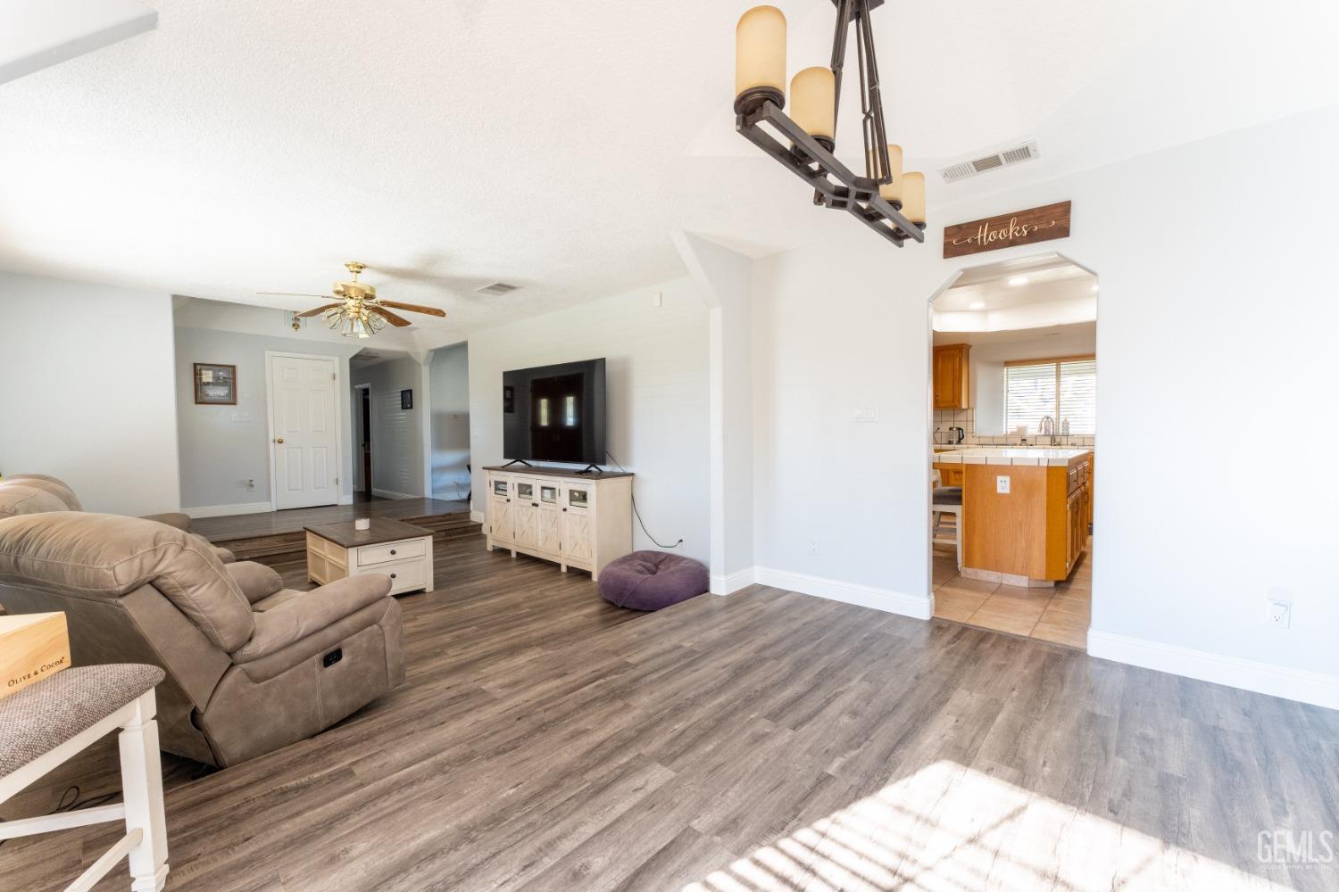 Undisclosed Address Bakersfield, CA 93314 - Photo 8 of 23 a living room with furniture and a flat screen tv