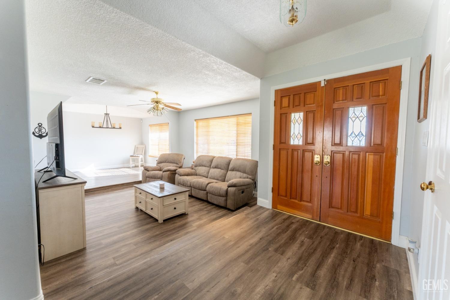 Undisclosed Address Bakersfield, CA 93314 - Photo 9 of 23 a living room with furniture and a wooden floor
