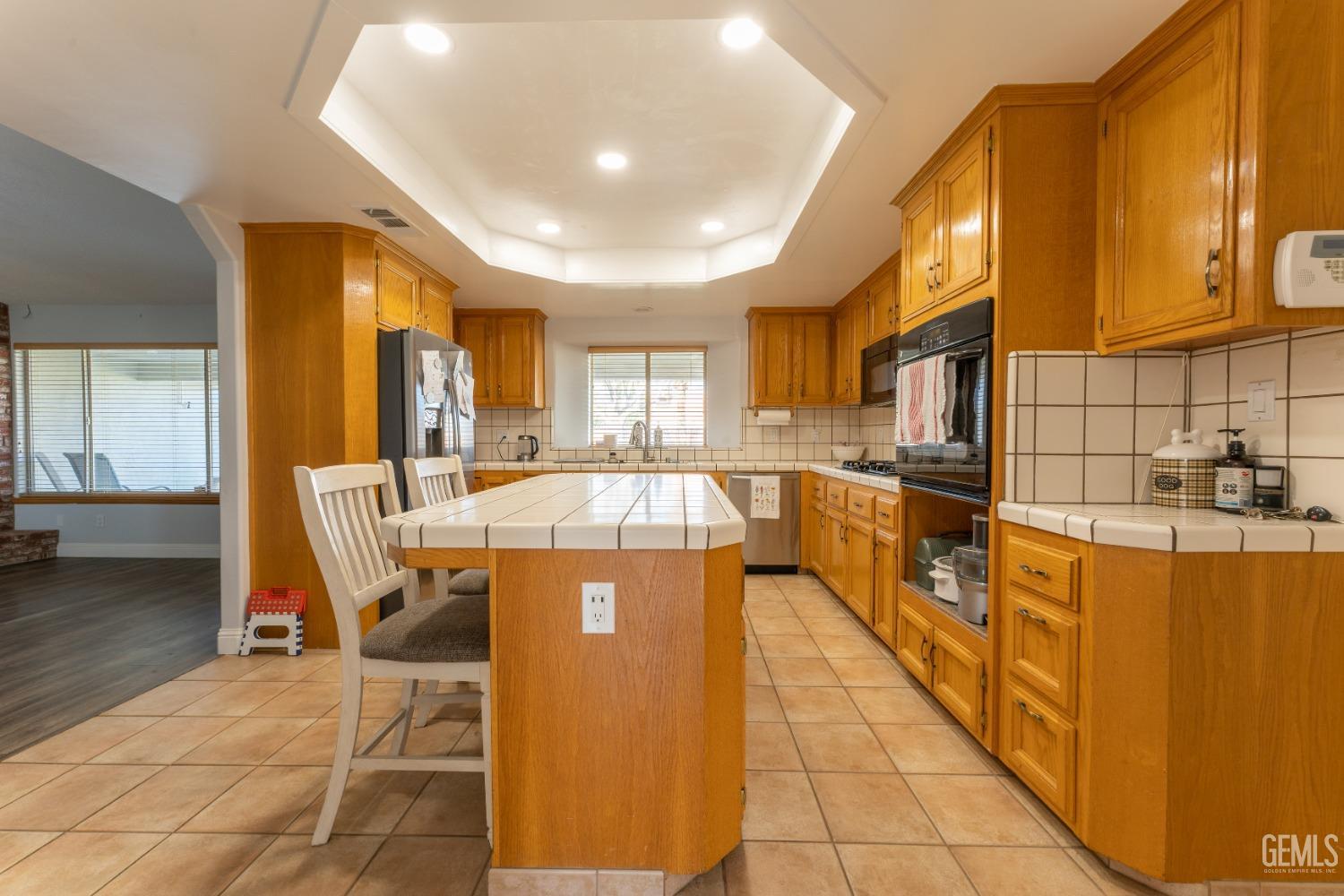 Undisclosed Address Bakersfield, CA 93314 - Photo 10 of 23 a kitchen with stainless steel appliances granite countertop a stove a sink a refrigerator and cabinets