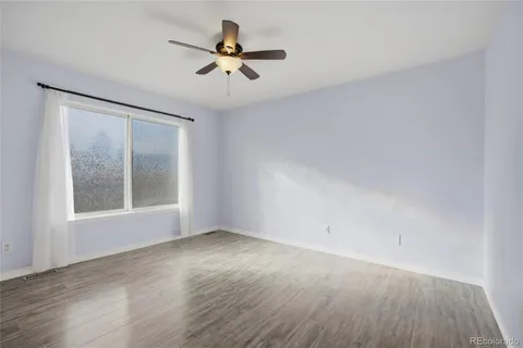 wooden floor in an empty room with a window